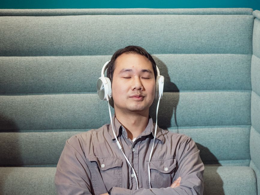 Viewer wearing headphones immersed in a cam show audio experience