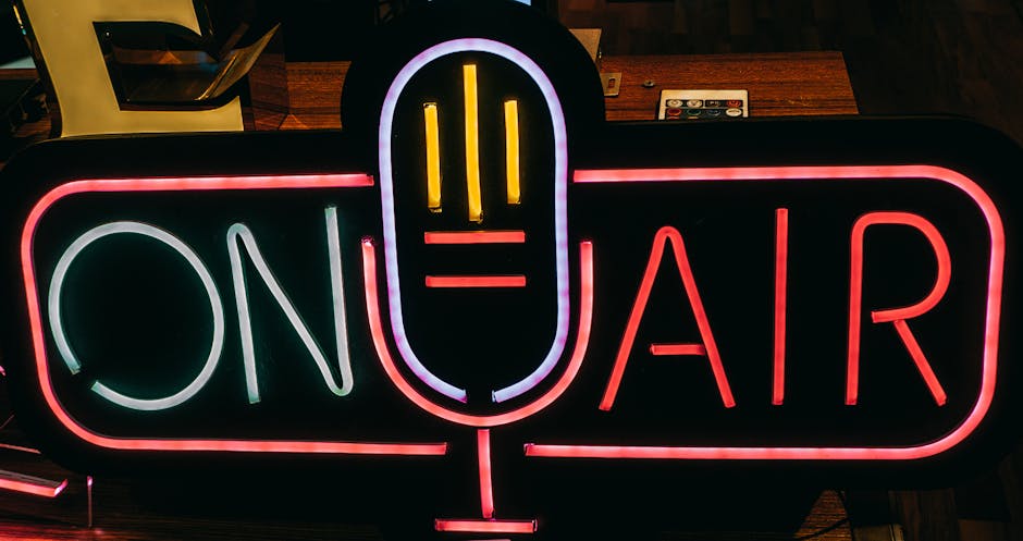 Microphone and headset glowing in a neon-lit cam studio