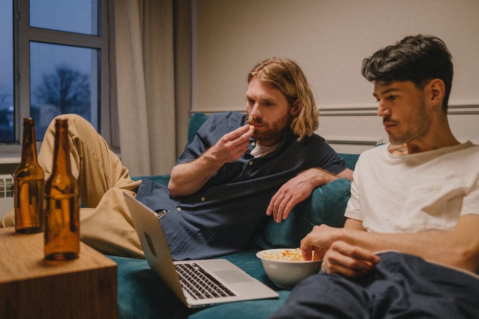 Person watching a themed live cam show on laptop at night