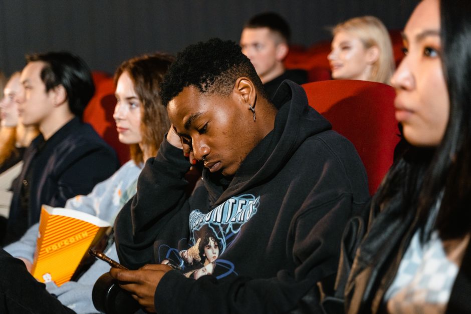 Diverse group of adults viewing content on mobile devices