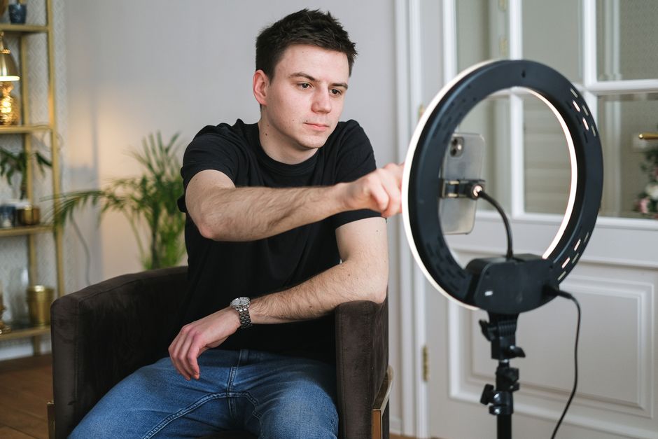 A professional cam studio lit with neon ring lights