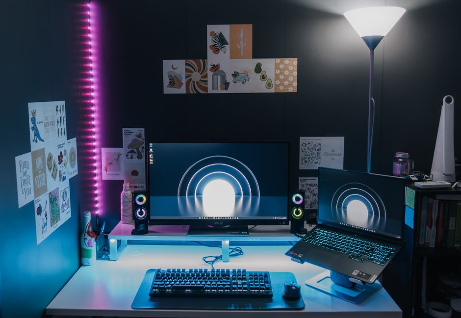 Professional cam broadcast setup with neon lighting and dual monitors