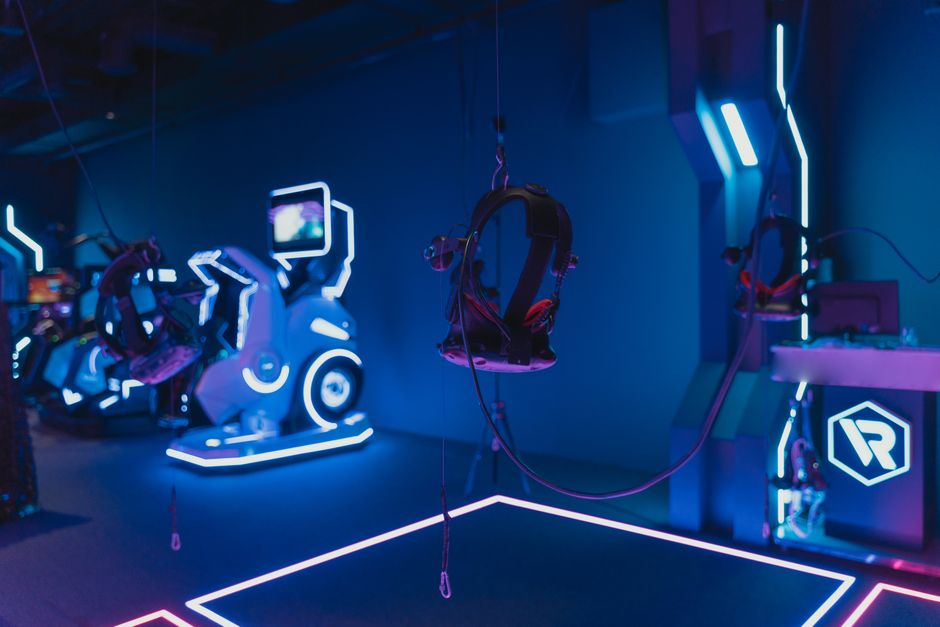 Person wearing VR headset in immersive neon environment