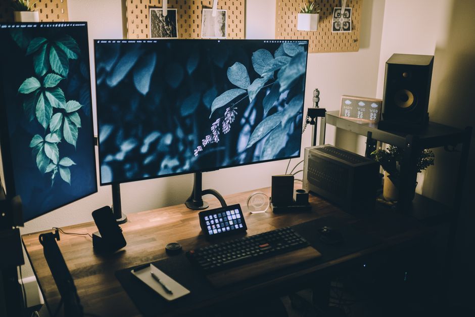 Dual monitor creator workstation with warm lighting and content calendar