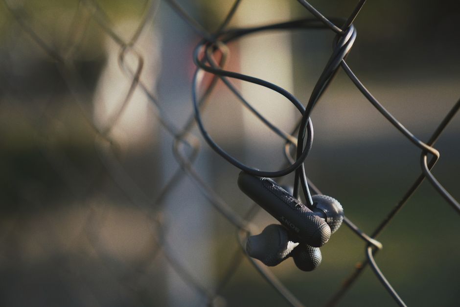 Futuristic headphones with glowing abstract audio waves