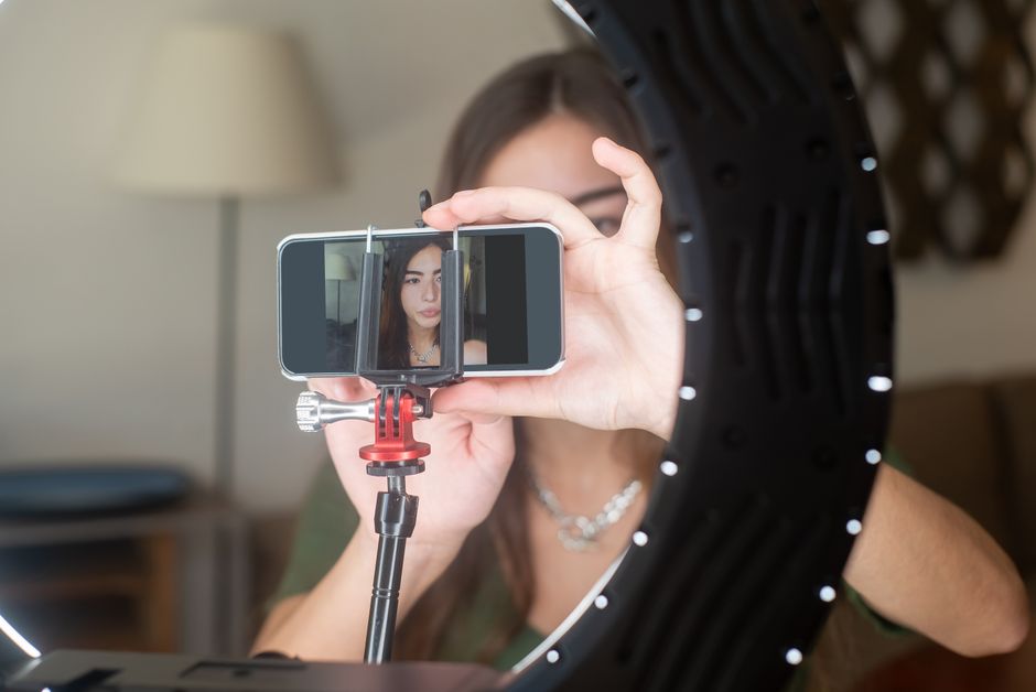 A professional webcam studio with neon lighting and ring light setup